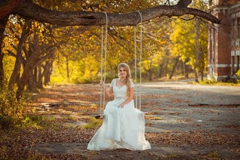 Woman in White Wedding Gown Sitting on Swing Hanging on Tree