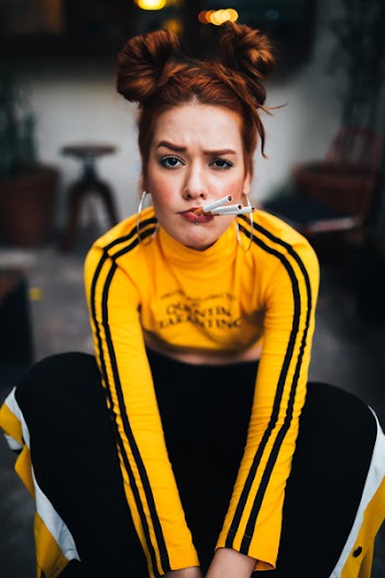 Woman in Yellow and Black Long-sleeved Shirt and Black Pants