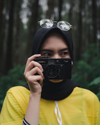 Woman in Yellow Crew Neck T-shirt Holding Black Camera