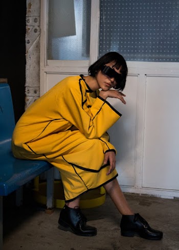 Woman in Yellow Dress Sitting on Blue Bench