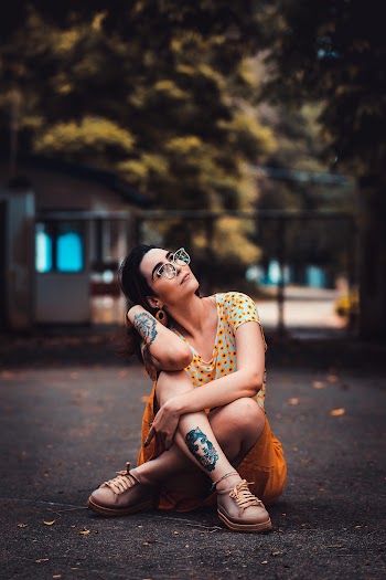 Woman in Yellow Dress Sitting on Ground on Selective Focus Photography