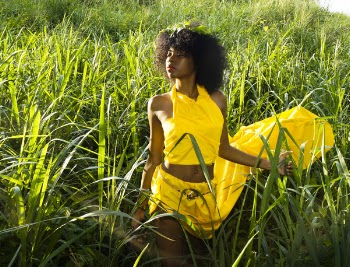 Woman In Yellow Dress Standing On Tall Grass