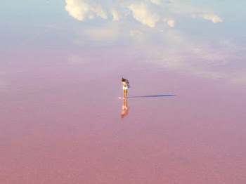 Woman in Yellow Dress Walking on Brown Sand Under Blue Sky · Free Stock Photo