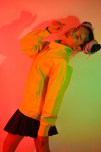 Woman in Yellow Jacket and Black Skirt