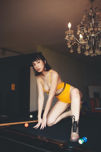 Woman in Yellow-orange Bikini on Top Billiard Pool Table