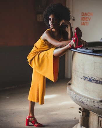 Woman in Yellow Pants Put Right Leg on Gray Machine