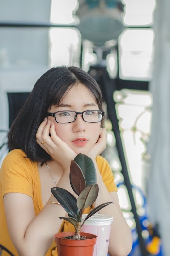 Woman in Yellow Scoop Neck Shirt and Black Framed Eyeglasses