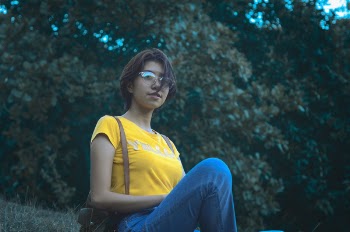 Woman in Yellow Short-sleeved Top and Blue Denim Jeans
