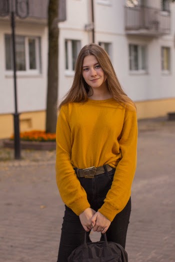 Woman In Yellow Sweater Holding Bag