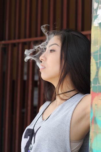 Woman Inhaling Smoke