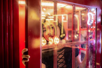 Woman Inside A Phone Booth