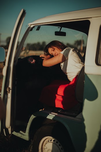 Woman Inside Van While Leaning On Steering Wheel