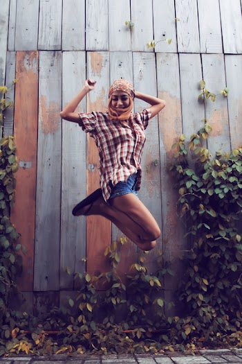 Woman Jumping Beside the Wall