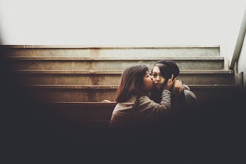 Woman Kissing Another Woman On Cheek