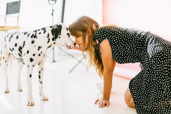 Woman Kissing White and Black Dalmatian