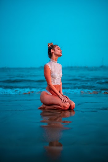 Woman Kneeling At The Beach