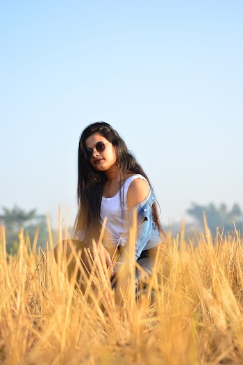 Woman Kneeling on Brown Grass
