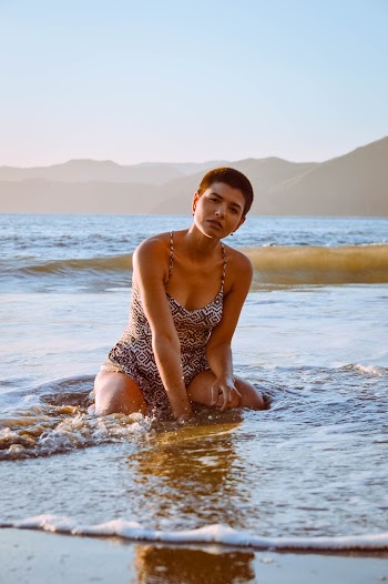 Woman Kneeling On Shore 