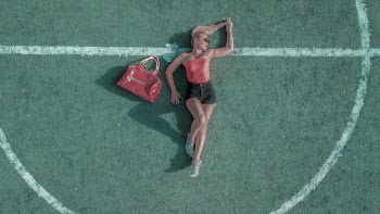 Woman Laying And Posing On Court