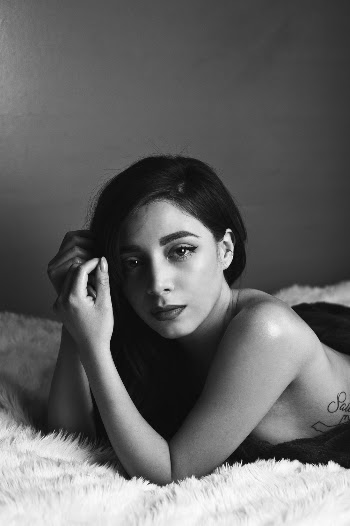 Woman Laying Down on Bed