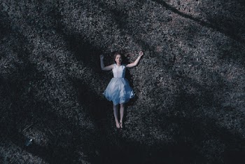 Woman Laying Down On Ground