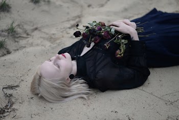 Woman Laying Holding Red Flowers