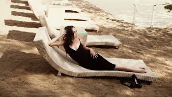 Woman Laying on Beige Lounger