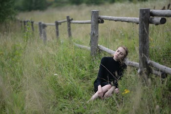 Woman Laying on Brown Fence