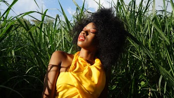 Woman Laying On Grass Field
