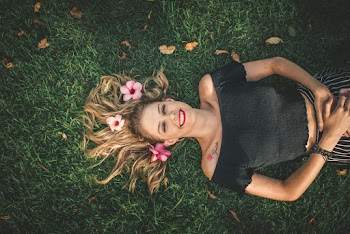Woman Laying On Green Grass