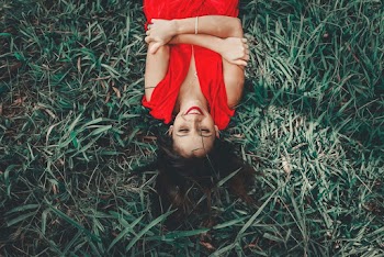 Woman Laying On Green Grass Field