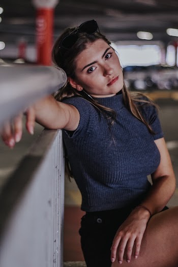 Woman Lean on Concrete Surface