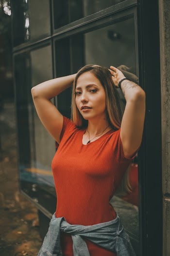 Woman Leaning Against Glass Window