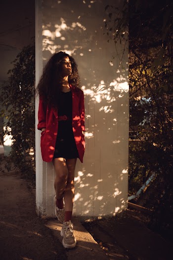 Woman Leaning Against Wall