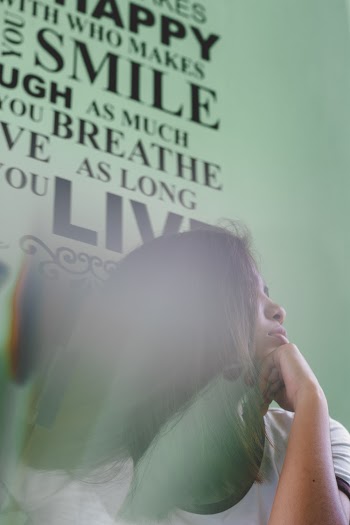 Woman Leaning Against Wall