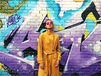 woman leaning back at the wall