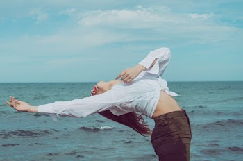 Woman Leaning Backward Near Body of Water