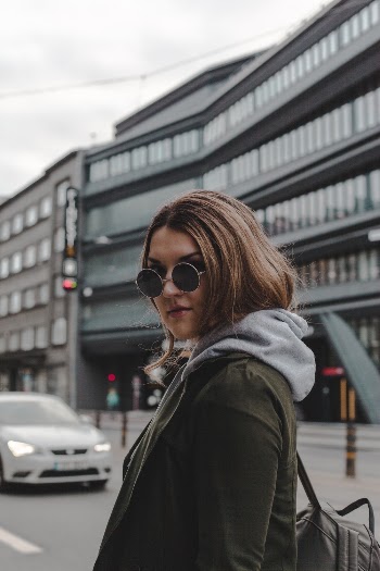 Woman Leaning Backward Wearing Sunglasses and Coat