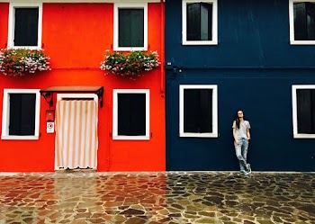 Woman Leaning Beside Blue Structure
