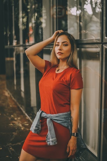 Woman Leaning Beside Glass Wall