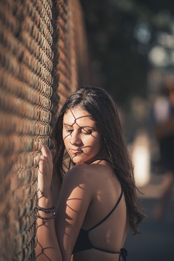 Woman Leaning Beside Wire Fence