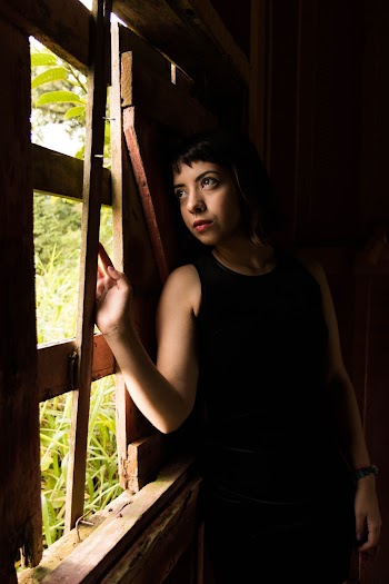 Woman Leaning by a Wooden Window