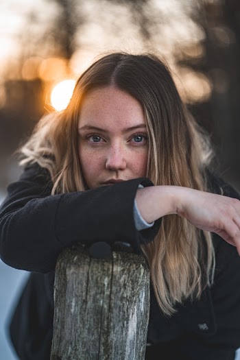 Woman Leaning Forward on Wood Plank