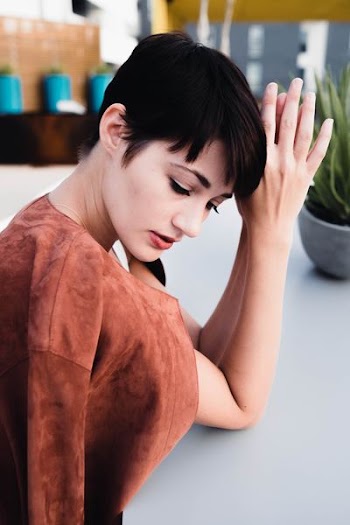 woman leaning her elbows on table