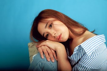 Woman Leaning Her Head on Her Knee