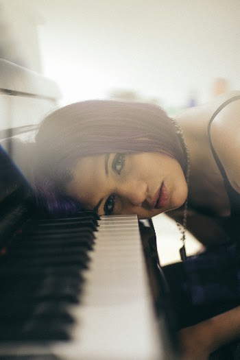 Woman Leaning Her Head on Piano Keys