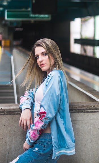 Woman Leaning Her Right Elbow on Railing