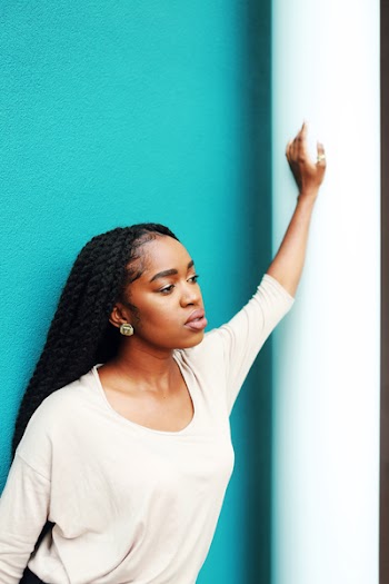 Woman Leaning Left Hand on Wall