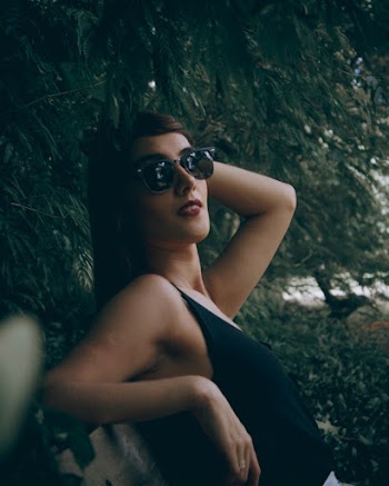 Woman Leaning Near Plants