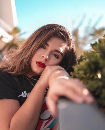 Woman Leaning Near Plants